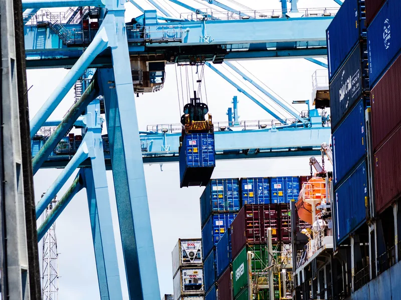 Container being lifted by quay crane
