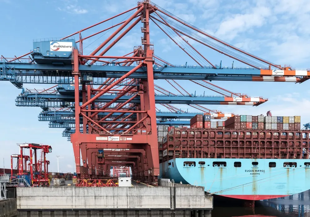 Container vessel under gantry cranes at a commercial port